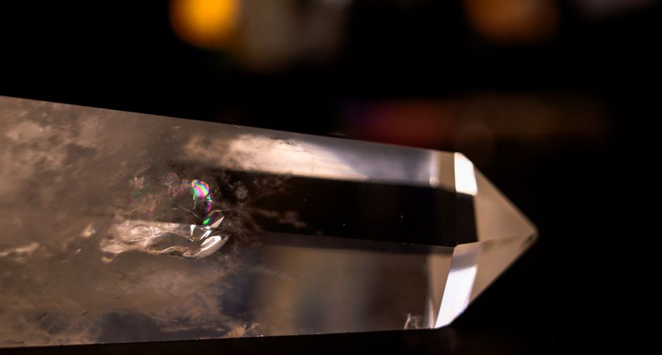 Clear quartz point with rainbow inclusion